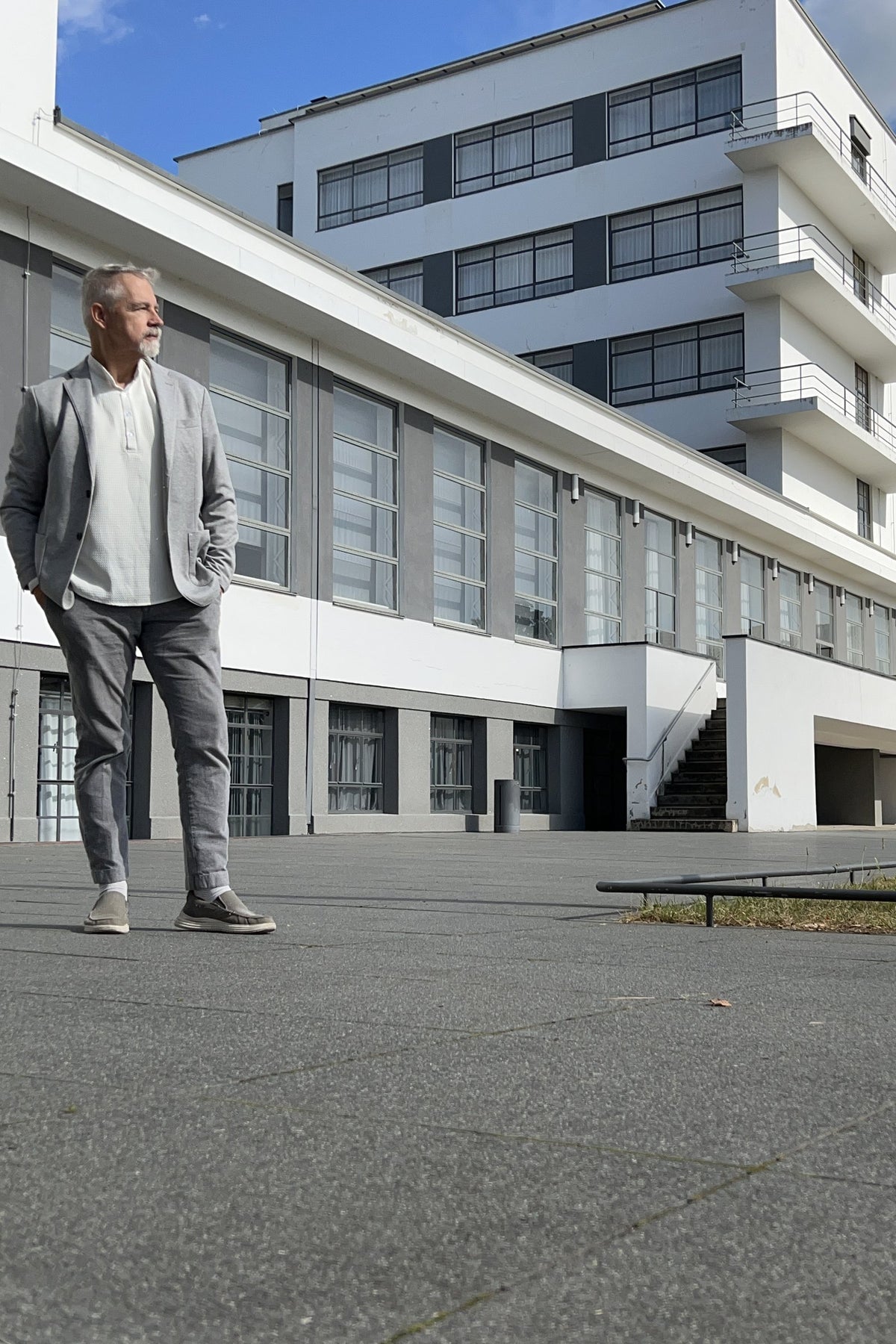 DeWitt Kendall standing in front of a modernist white building